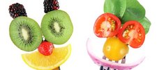 Obst und Gemüse als Gesichter auf Gabeln gespießt