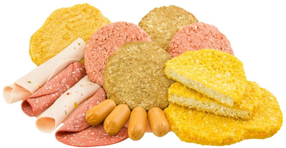 Aufgerollte Scheiben Fleisch-Ersatz, vegane und vegetarische Burger-Scheiben und Würstchen sind abgebildet.