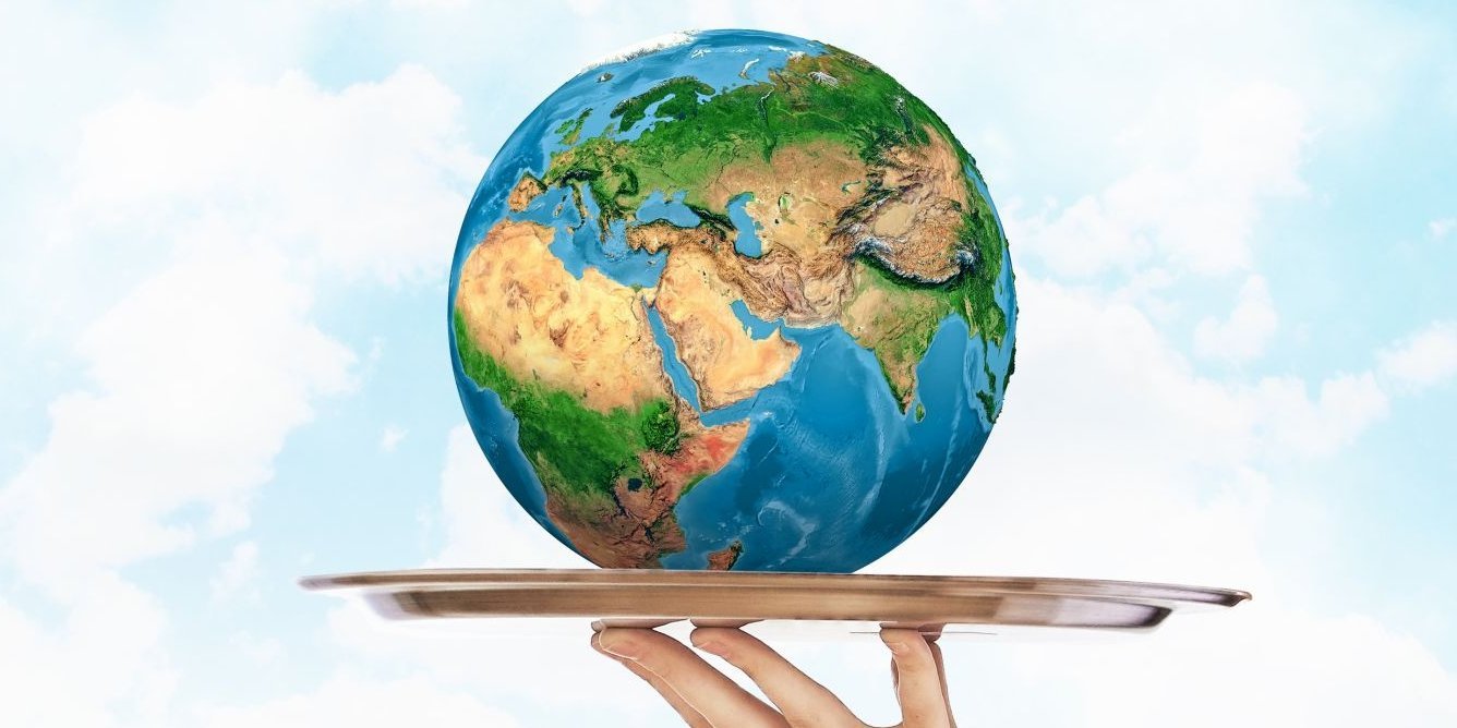 Eine Hand hält ein rundes Metall-Tablett, auf dem eine Weltkugel liegt.. Artikel "Nachhaltiges Essen für Mensch und Erde" öffnen.