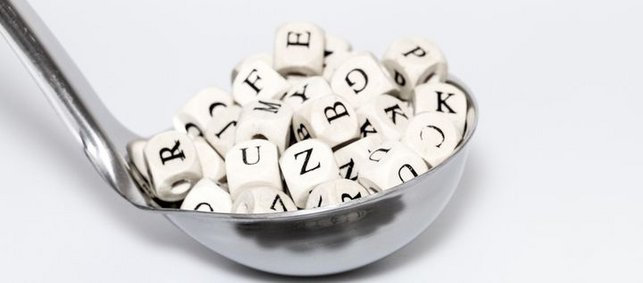 Eine Suppenkelle mit Buchstabenwürfeln