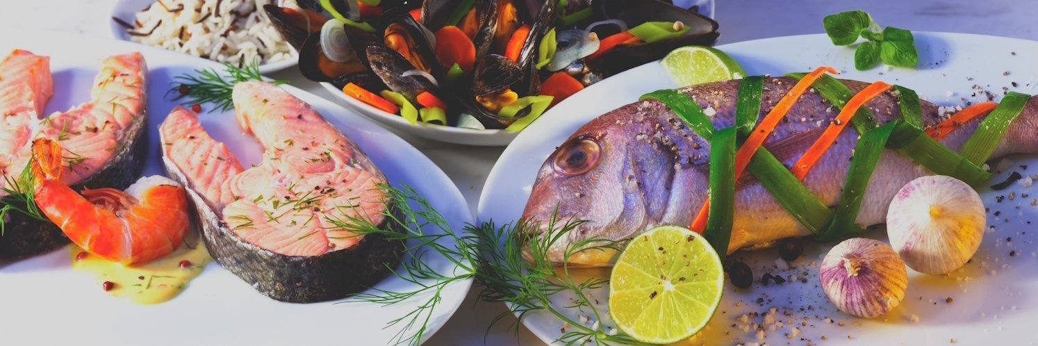 Drei Teller mit Fisch, Garnelen und Muscheln.