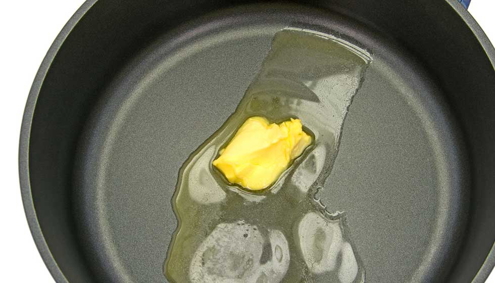 Butter zerfließt in einer heißen Pfanne